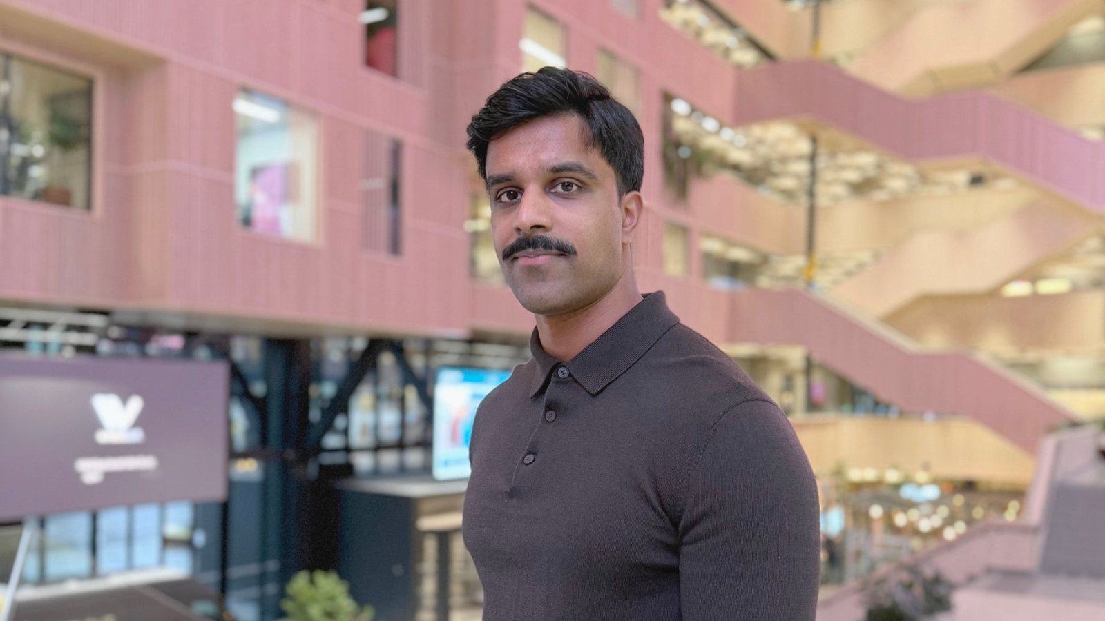 Inthujan Rasalingam, co-founder and CEO of Capacity Connect, in the pink atrium of Construction City in Oslo